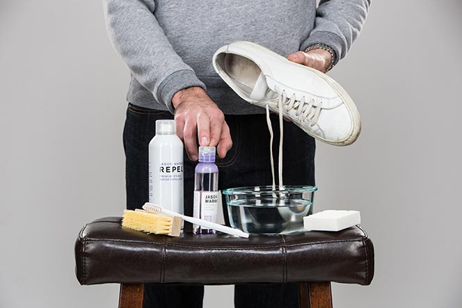 clean white shoes with toothbrush
