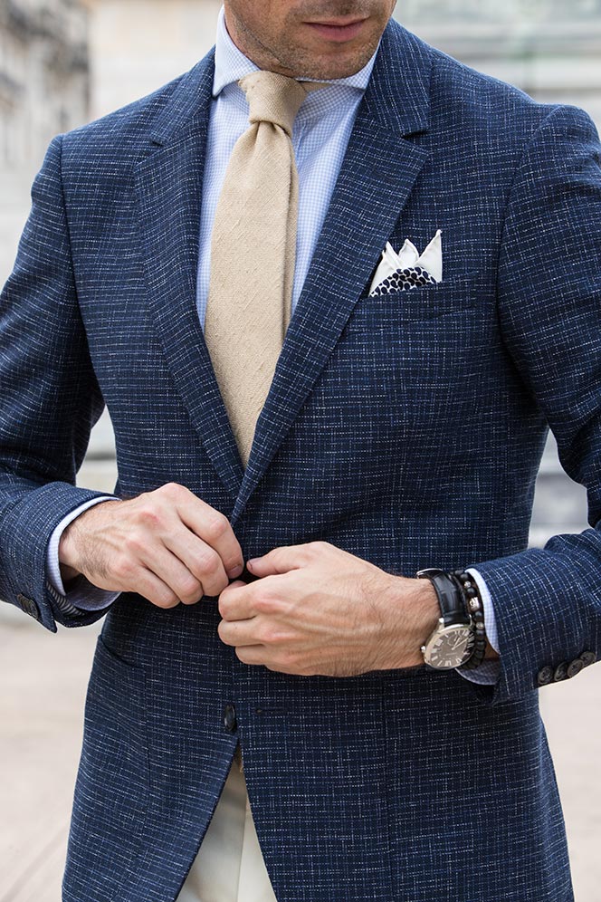 blue-blazer-white-texture-tan-tie-spread-collar-shirt-cartier-watch-bead-bracelet-details-late-summer-wedding-mens-outfit-idea.jpg