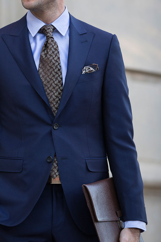 Man in a light blue suit with brown accessories