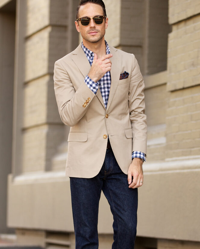 Looking elegant wearing a stripped blazer with a white shirt, beige  trousers and blue suede loafers