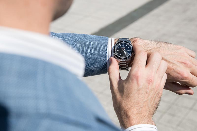movado-series-800-watch-black-dial-bezel-steel-with-light-blue-linen-blazer-3