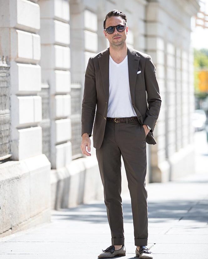https://hespokestyle.com/wp-content/uploads/2016/07/brown-cotton-suit-white-v-neck-t-shirt-persol-649-sunglasses-wearing-suit-with-t-shirt-mens-summer-outfit-ideas-8-664x826.jpg