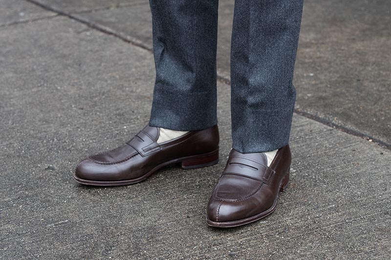 brown-leather-penny-loafers-with-cream-colored-socks-grey-flannel-pants-2
