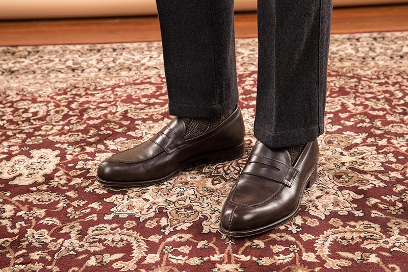 dark-brown-chocolate-leather-penny-loafers-with-grey-wool-pants-on-persian-rug