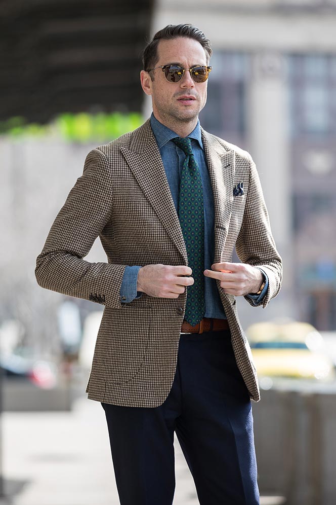 houndstooth-blazer-navy-pants-denim-cutaway-collar-shirt-green-medalion-print-tie-spring-business-casual-outfit-ideas-men-buttoning-suit-jacket