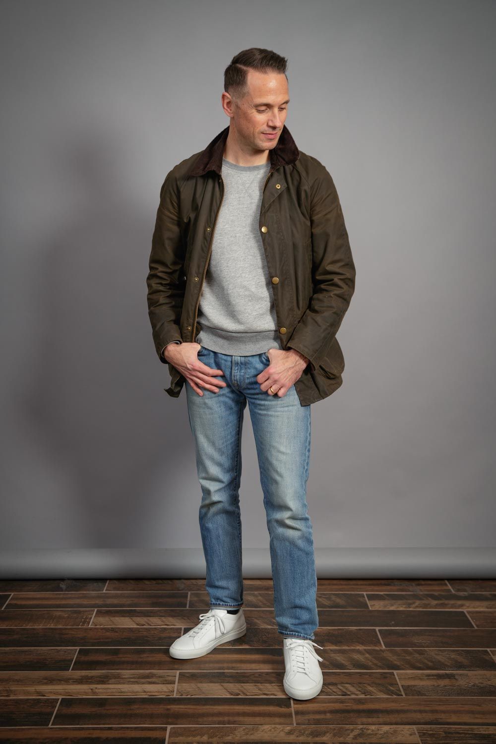 Barbour-waxed-jacket-for-men-heather-grey-casual-sweatshirt-light-wash-jeans-common-projects-sneakers