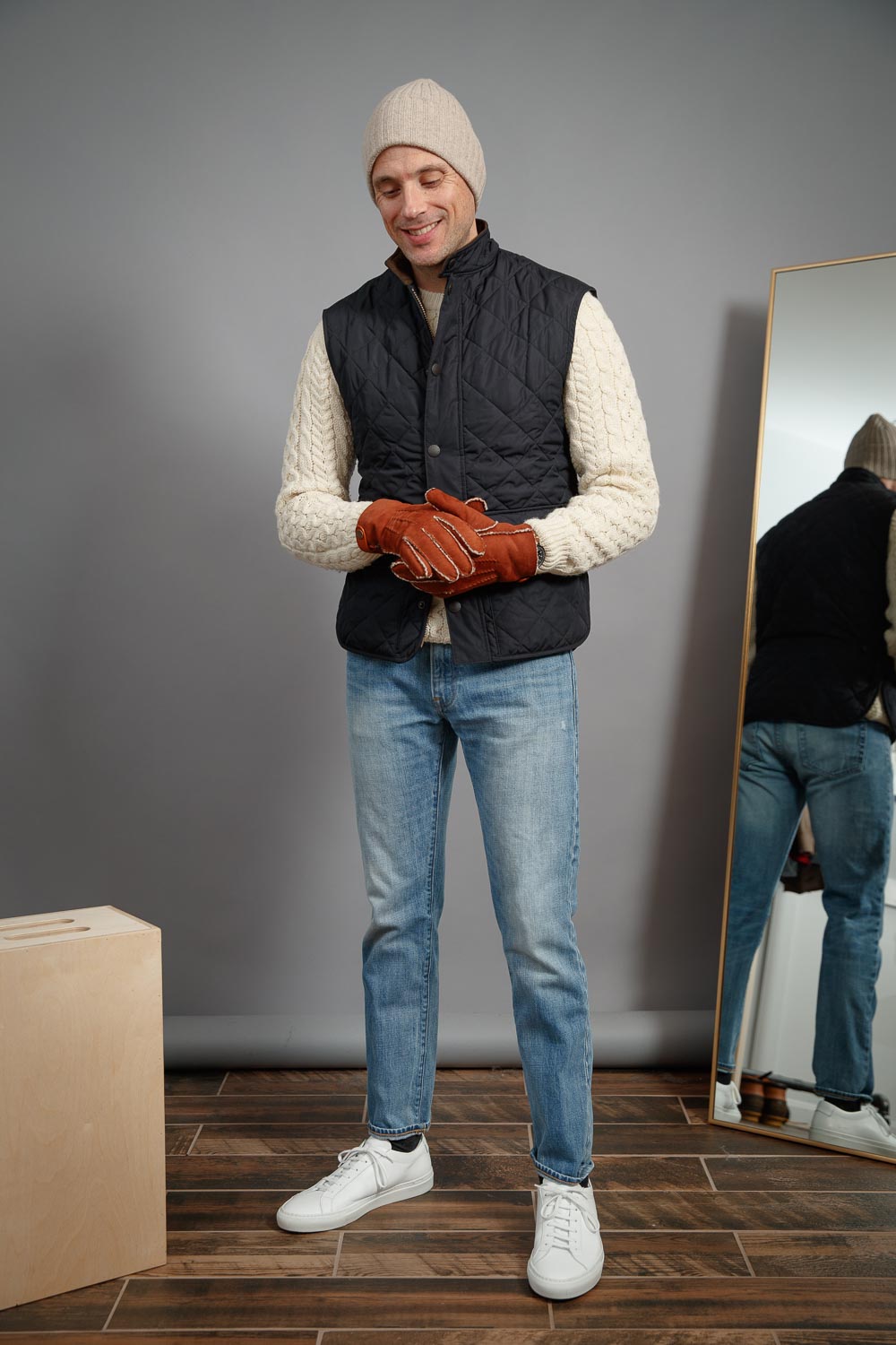 Light-wash-jeans-with-common-projects-sneakers-hilts-willard-gloves-barbour-vest-best-casual-winter-style-ideas