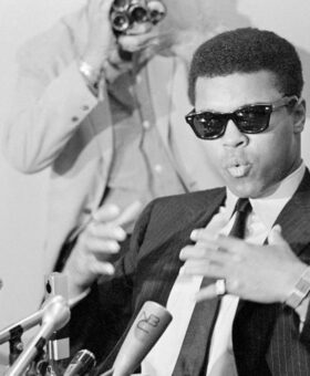 Muhammed Ali wearing Ray-Ban sunglasses