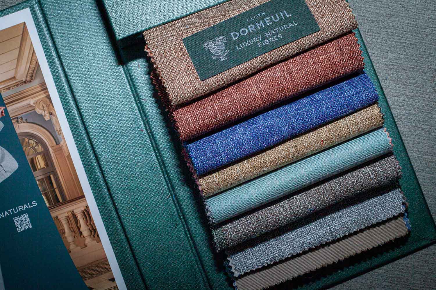 A Dormeuil fabric book with natural fibers