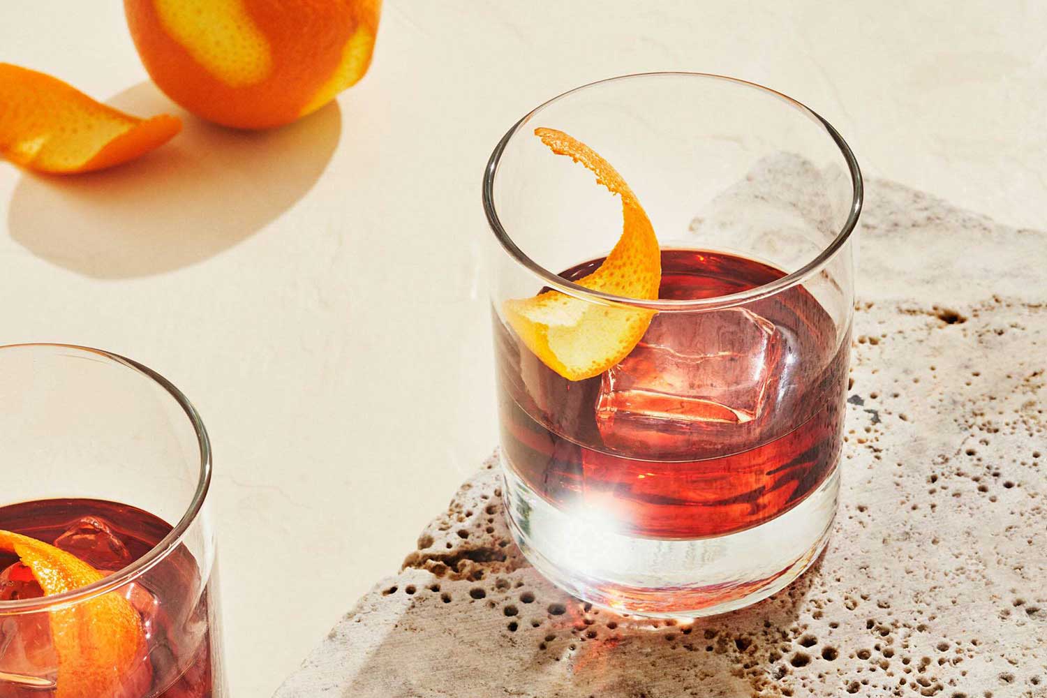 A Negroni garnished with an orange peel.