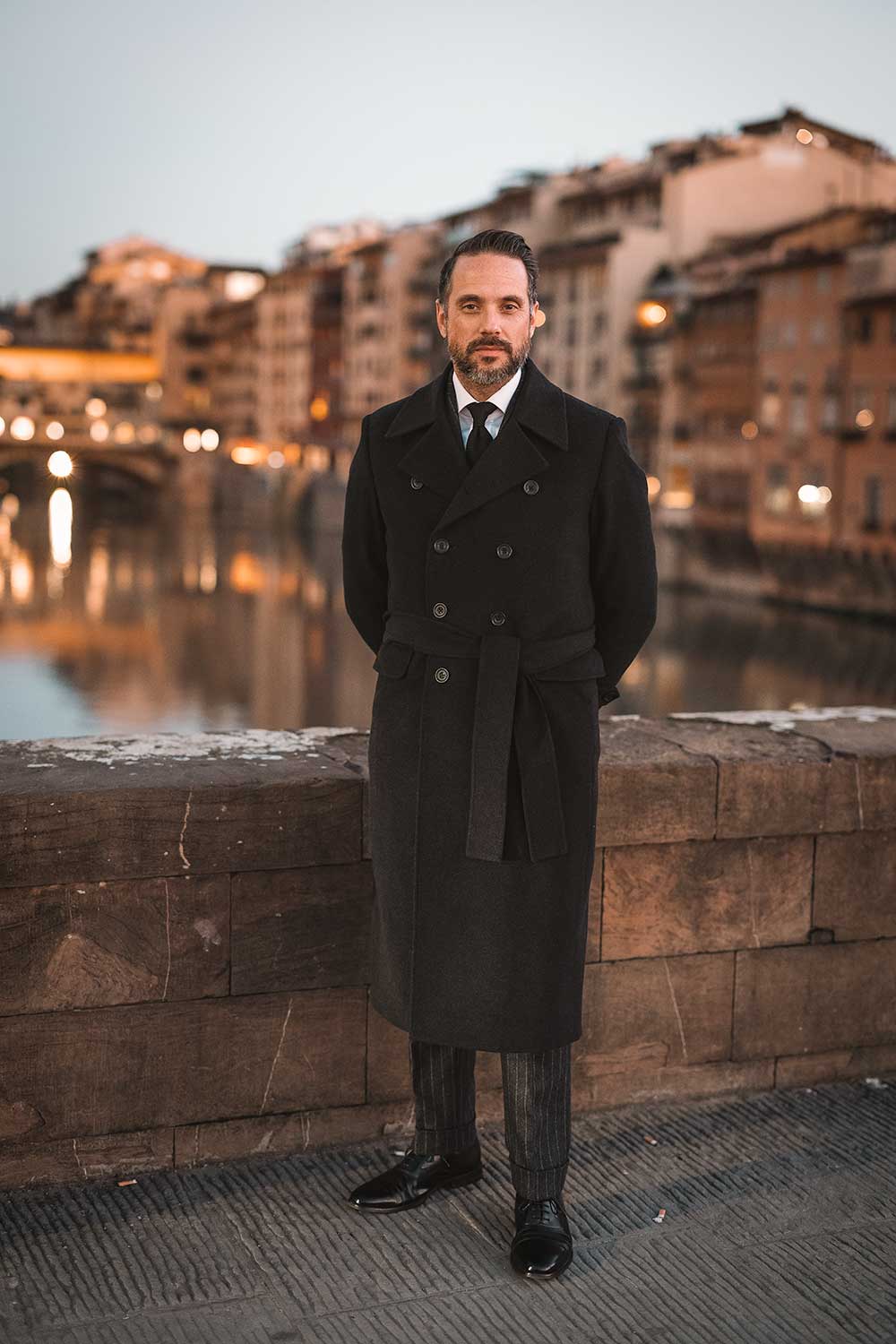 wearing a charcoal wool and cashmere belted greatcoat 