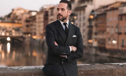 wearing a gray chalkstripe flannel suit for a formal occasion