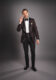 Brown jacquard shawl collar dinner jacket with pique stud shirt, black bow tie and cummerbund