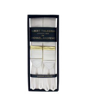 White solid suspenders with gold hardware and white leather ends, in a gift box