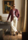 Burgundy sport coat with pink shirt, cream trousers and suede loafers, worn by a model
