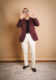 Burgundy wool sport coat with black tee, cream trousers and brown tassel loafers, worn by a model