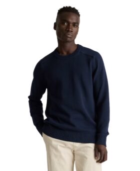 Navy cotton crewneck sweater with ribbed trim, worn with cream trousers by a model