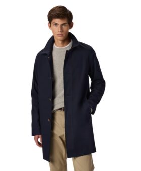 Navy single-breasted car coat with spread collar, over a grey crewneck sweater and tan trousers, worn by a model